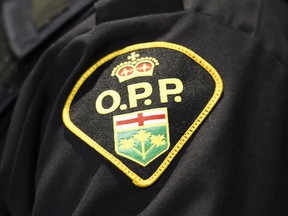 Files: OPP logo.  Provincial police remain on the scene today in an Ontario town where hundreds of modified cars descended this weekend for stunt driving, racing and other alleged dangerous driving behaviours. OPP Sgt. Jason Folz says the "car takeover" in Wasaga Beach, Ont. began Friday and continued early Sunday