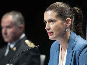Quebec Deputy Premier and Public Security Minister Genevieve Guilbault during a news conference on the COVID-19 pandemic, Friday, September 18, 2020 in Quebec City. Guilbault announced interventions by police forces across the province. Quebec City police director Robert Pigeon, left, looks on.