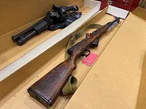 The SKS semi-automatic rifle and shotgun that were seized from the apartment of Matthew Raymond after his arrest are seen during a media access session to evidence on the first day of the trial at the Court of Queens Bench in Fredericton, N.B., Tuesday, Sept. 15, 2020.