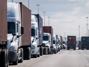 FILE: Trucks wait in line.