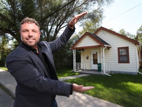 Agent Zak Green poses for a photo in front of 256 Northwestern Ave. in Westboro. This one bedroom house sold for $1 million after being listed at $699,000.