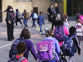 Students enter the Philippe-Labarre Elementary School in Montreal, on Thursday, August 27, 2020. Thousands of Quebec students return to class in the shadow of the COVID-19 pandemic.