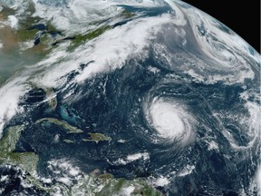 This GOES-16 GeoColor satellite image taken Friday, Sept. 18, 2020, at 12:20 p.m. EDT., and provided by NOAA, shows Hurricane Teddy, center, in the Atlantic, Tropical Depression 22, left, in the Gulf of Mexico, the remnants Paulette, top right, and Tropical Storm Wilfred, lower right. Forecasters have run out of traditional names for the Atlantic hurricane season. Tropical Storm Wilfred, the last of traditional names, officially formed little more than an hour before subtropical storm Alpha, prompting the hurricane center to tweet "get out the Greek alphabet."