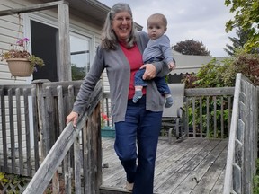 “I need to change the hand rails on my stairs to ensure my safety and my grandson's safety when I carry him,” says Nancy Edwards, pictured on the stairs with her six-month-old grandson.  "A pincer grasp on my current handrail does not give me a strong enough grip."