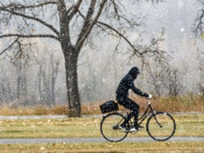 File photo/ A cyclist rides in some not-so-great weather.