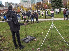 Scott Ruffo, co-owner of The Brass Monkey, led the OpenSafe Ottawa rally Saturday.