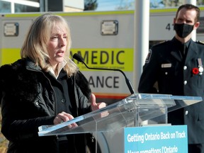 Ottawa Paramedic Service Chief Pierre Poirier, right, listens to the comments of Minister of Long-term Care Merrilee Fullerton during the announcement of $5 million in funding for a community paramedic program intended to help people waiting for long-term care placements to stay safely at home.