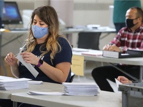 Election officers count the special mail-in ballots for the Ward 19 Cumberland byelection Monday.