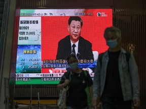 A live broadcast of Chinese President Xi Jinping delivering a speech in the city of Shenzhen is shown on a public screen in Hong Kong, China, on Wednesday, Oct. 14, 2020.