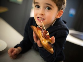 Four-year-old Brandon Segal enjoyed his yummy pizza from Revival Pizza on their opening night.