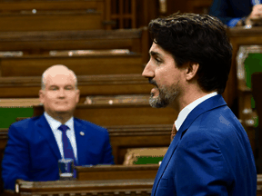 Conservative leader Erin O’Toole listens as Prime Minister Justin Trudeau speaks in the House of Commons on Wednesday, Oct. 21, 2020.