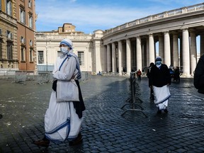 Files: Missionary Sisters of Mother Teresa of Calcutta, wearing a face masks walk past St. Peter's Square colonnades, Vatican, on October, 13, 2020.