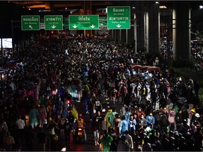 Pro-democracy protesters walk along a road during an anti-government rally at the Lat Phrao intersection in Bangkok on October 17, 2020, as they continue to defy an emergency decree banning gatherings.