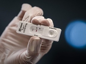 A medical personnel holds a new rapid-result COVID-19 antigen test at the Saint-Andre hospital in Bordeaux on October 20, 2020.