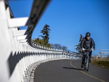 A cyclist crosses over the Rideau Canal using the Flora Footbridge in the Glebe on a sunny Saturday.