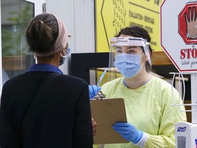 A nurse greets a woman.