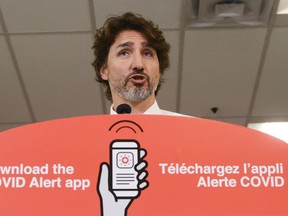 Prime Minister Justin Trudeau holds a press conference – with bilingual signage, of course.