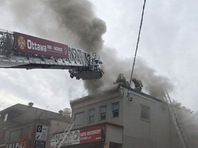 Ottawa Fire Services battles a fire on the upper floor of a building at 270 Preston St. Thursday morning