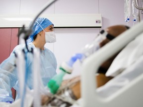 A nurse treats a COVID-19 patient in the intensive care unit (ICU). File photo