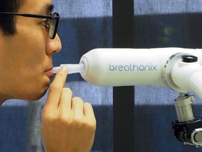 A staff member demonstrates the usage of Breathonix breathalyzer test kit developed by Breathonix, a start-up by the National University of Singapore, able to detect the coronavirus disease (COVID-19) within a minute according to the company, at their laboratory in Singapore.