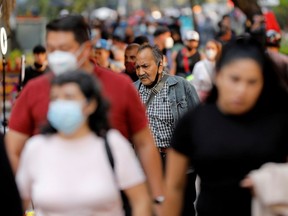 People walk on a street in Mexico City earlier this month.