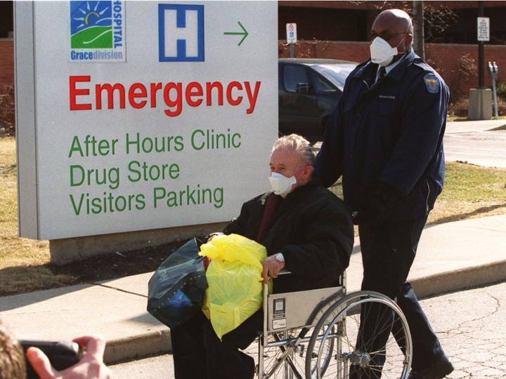  A patient is wheeled out Scarborough Grace Hospital by security in 2003 during the SARS outbreak.