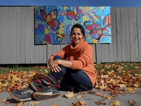 OTTAWA - Artist Claudia Salguero poses for a photo in front of her mural at the Ottawa Community Housing office at 731 Chapel Street in Ottawa Tuesday October 20, 2020.