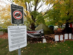 NCC workers install no camping signs at Confederation Square beside the National War Memorial in Ottawa Thursday October 15, 2020.