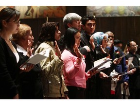 This file photo shows a special citizenship ceremony at the Canadian War Museum in 2010. Canada's charitable sector has been boosted by the generosity of immigrants and multicultural communities.