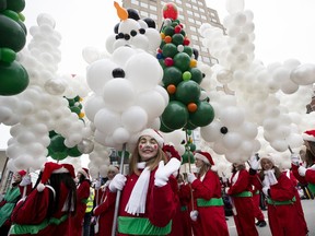 One of Santa's many helpers performs for the crowd during the annual Santa Claus parade on Nov. 23, 2019.