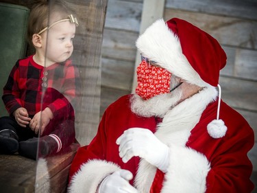 Eleven-month-old Hazel Leibovitch checks out Santa on Saturday at Hazeldean Mall.