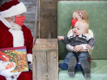 Six-year-old Paisley Bell and her little brother, 10-month old Bryson, spend some time with Santa on Saturday.