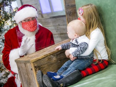 Six-year-old Paisley Bell and her little brother, 10-month old Bryson, spend some time with Santa on Saturday.