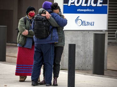 Protesters for Indigenous and Black rights rallied outside Ottawa police headquarters on Elgin Street, Saturday, Nov. 21, 2020, where they demanded the release of 12 people arrested early Saturday morning, after another protest was shut down. Protestors embrace one of the 12 arrested after they were released Saturday morning.