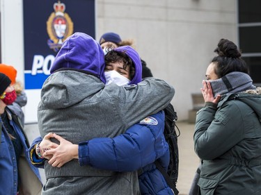 Protesters for Indigenous and Black rights rallied outside Ottawa police headquarters on Elgin Street, Saturday, Nov. 21, 2020, where they demanded the release of 12 people arrested early Saturday morning, after another protest was shut down. Protestors embrace one of the 12 arrested after they were released Saturday morning.