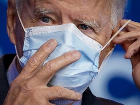 Joe Biden puts on his face mask after making remarks about the Affordable Care Act and COVID-19 after attending a virtual coronavirus briefing with medical experts at The Queen theater on October 28, 2020 in Wilmington, Delaware.