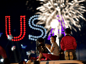 People watch fireworks after media announced that Democratic U.S. presidential nominee Joe Biden has won the 2020 U.S. presidential election, in Wilmington, Delaware, November 7, 2020.