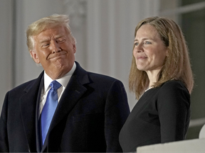 U.S. President Donald Trump, left, and Amy Coney Barrett, associate justice of the U.S. Supreme Court, on a balcony during a ceremony on the South Lawn of the White House in Washington, D.C., U.S., on Monday, Oct. 26, 2020.
