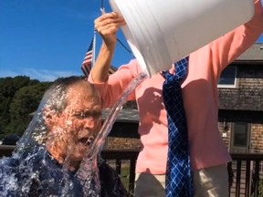 A framegrab from social media video of former U.S. President George W. Bush taking the "Ice Bucket Challenge" with former First Lady Barbara Bush providing the dunking.