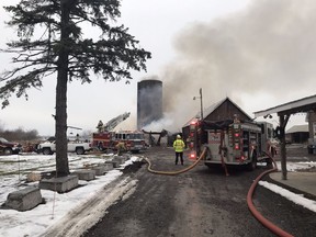 Firefighters battle a barn fire near Carp.