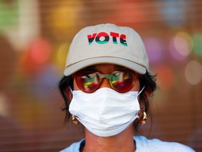 A person wearing a "Vote" cap attends an ecumenical worship service at Mi Familia Vota headquarters to promote the importance of the Latino vote in Phoenix, Arizona U.S., November 1, 2020. PHOTO BY EDGARD GARRIDO/REUTERS//File Photo ORG.