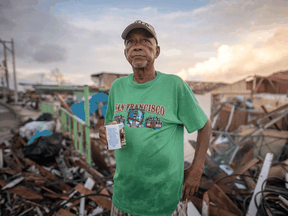 A man drinks a coffee amidst destruction from Hurricane Iota on November 23, 2020 at La Montaña sector in Providencia Island, Colombia.