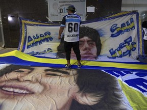Supporters of retired Argentine soccer star Diego Maradona gather outside the hospital where he had brain surgery for a blood clot on Tuesday.