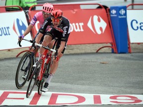 Stage winner Team Lotto rider Belgium's Tim Wellens (R) sprints with Team Education First rider Ottawa's Michael Woods as they arrive to the finish line of the 14th stage of the 2020 La Vuelta cycling tour of Spain, a 204.7-km race from Lugo to Ourense, on November 4, 2020.