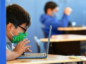 Students work on their laptop computers.