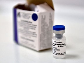 (FILES) This file photo taken on September 10, 2020 shows a vial of Russia's new coronavirus vaccine in a post-registration trials in Moscow. Russia's Sputnik V coronavirus vaccine is 95 percent effective according to a second interim analysis of clinical trial data, its developers said on November 24, 2020.