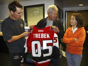 Alex Trebek and his 12 year old daughter Emily get a tour of the Ottawa Senator's dressing room after the forth day of the Ottawa Senators 2005-06 training camp in Ottawa. Wade Redden talked to the Trebek's after practice.