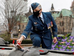 A Canadian Forces member lays a poppy on the Tomb of the Unknown Soldier following a ceremony at the National War Memorial on Remembrance Day 2020 in Ottawa. The Royal Canadian Legion says the annual event will be open to spectators this year.