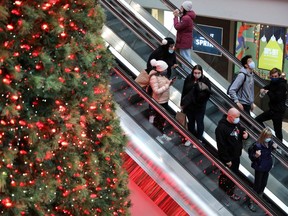 Shoppers wearing mandatory masks pass Christmas Tree, two days before coronavirus disease (COVID-19) restrictions are reintroduced to Greater Toronto Area regions, at Eaton Centre mall in downtown Toronto, Ontario, Canada November 21, 2020.