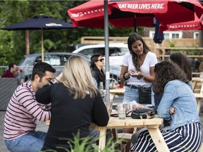 A server takes orders on the patio at  a restaurant in Ottawa.